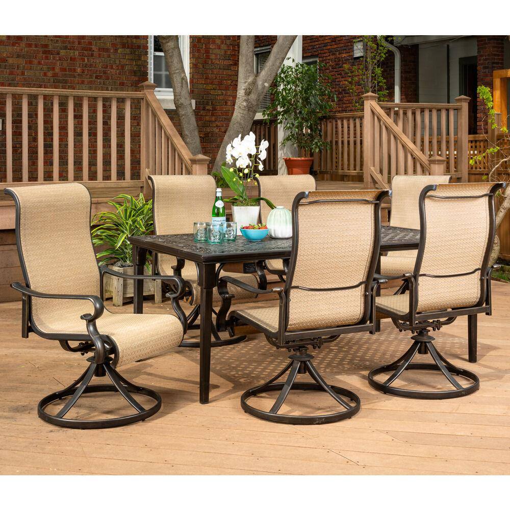 Hanover Brigantine 7-Piece Aluminum Outdoor Dining Set with a 40 in. x 70 in. Cast-Top Dining Table and 6-Sling Swivel Rockers
